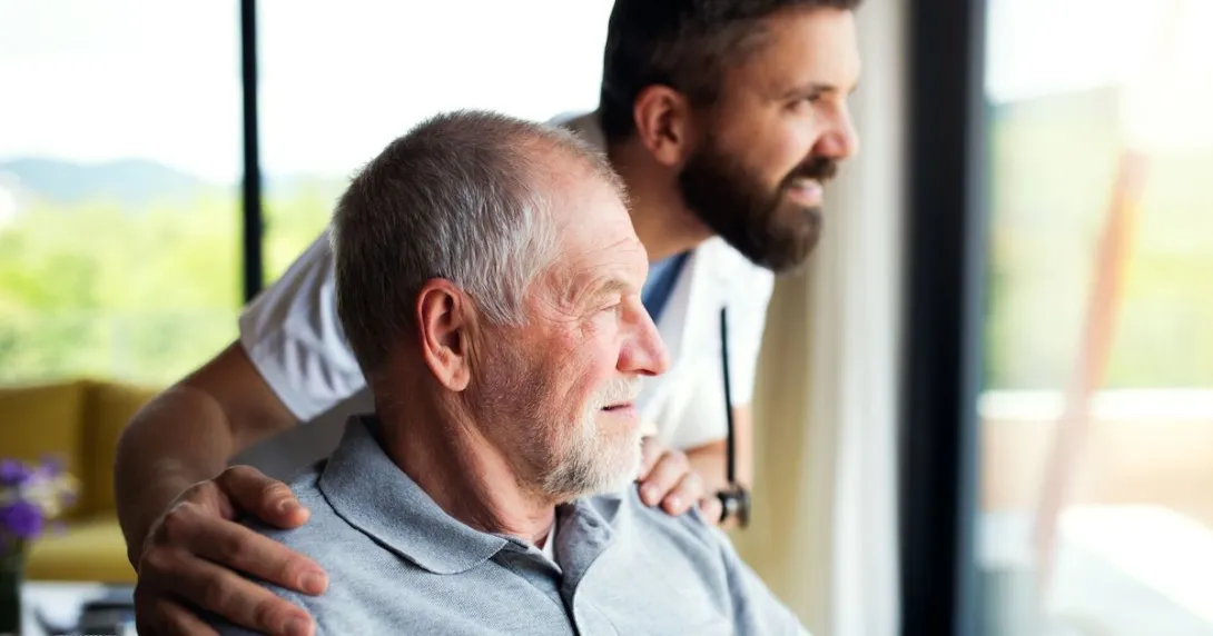 A man at home with a caregiver