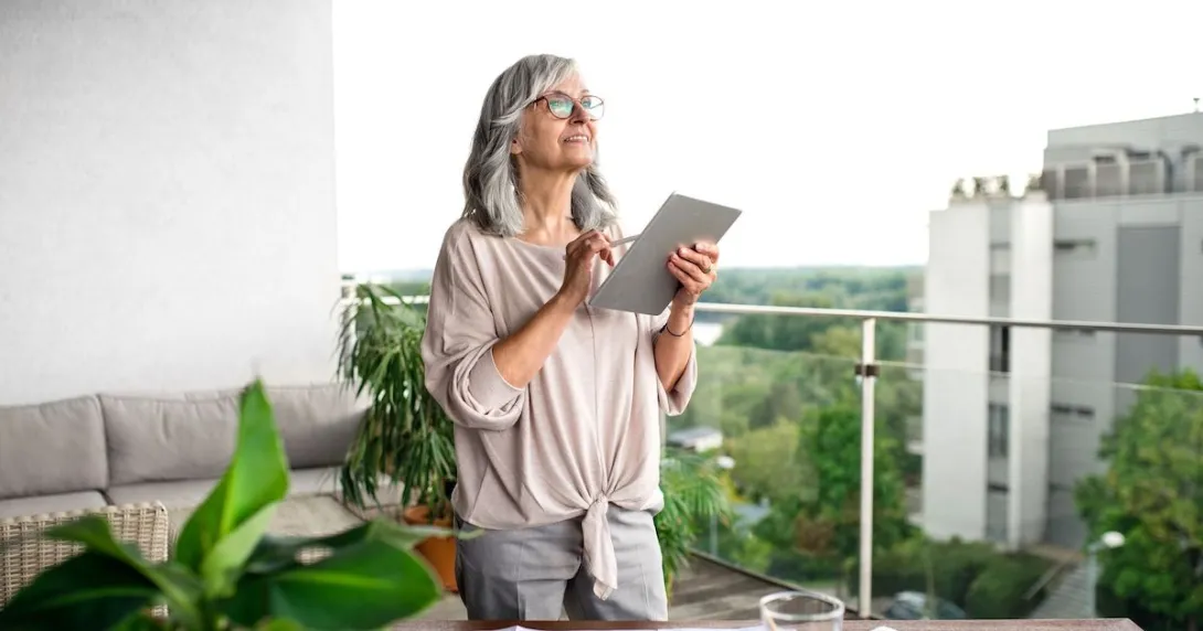 A woman using a tablet at her desk