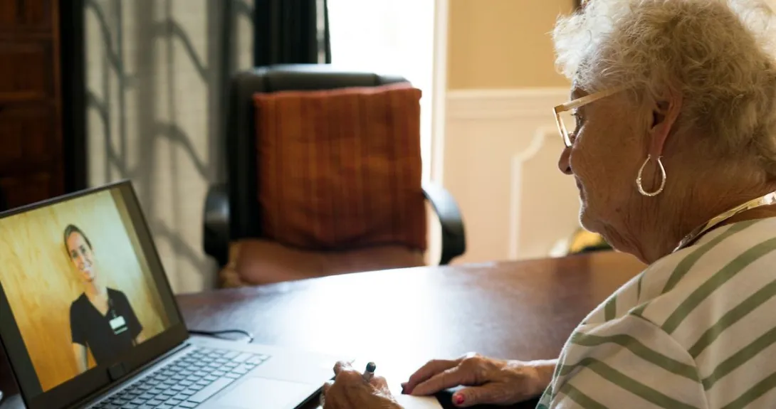 An older woman talks to a provider via telehealth