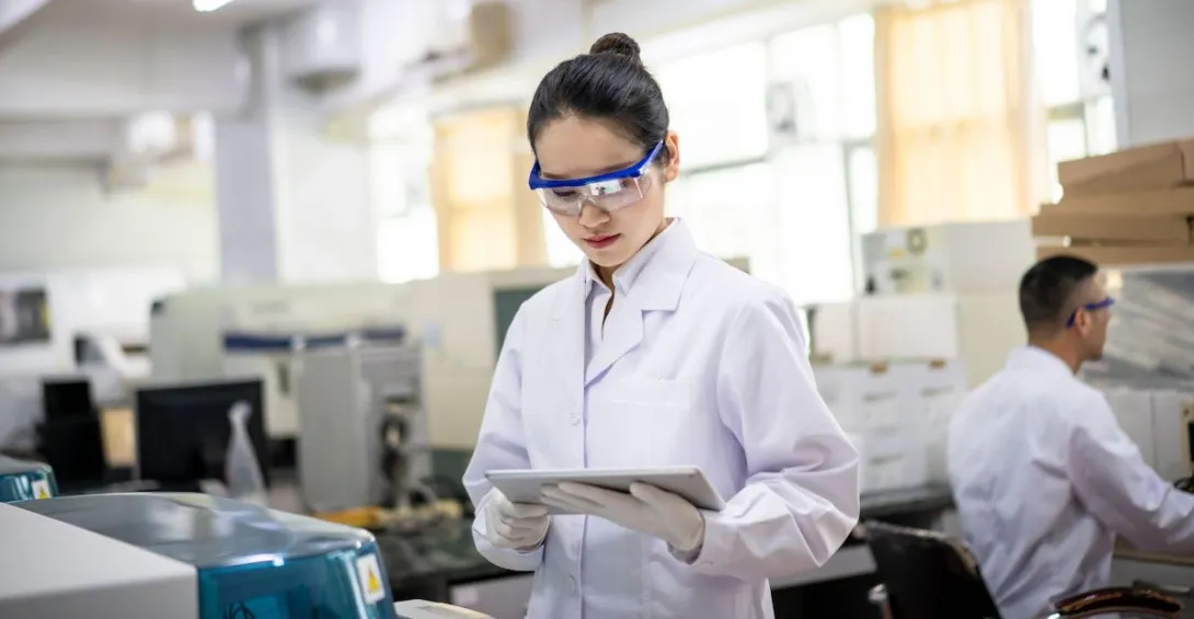 A researcher using her tablet in a lab