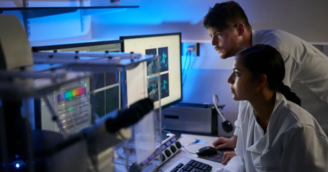 Researchers looking at data on a computer