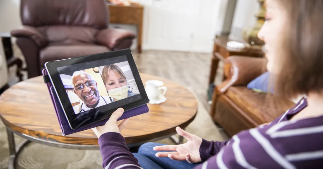 A young woman receiving healthcare through video call
