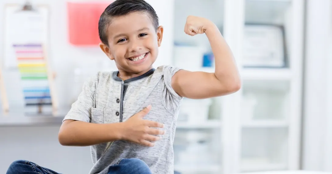 Person sitting in a clinic while flexing their arm muscles