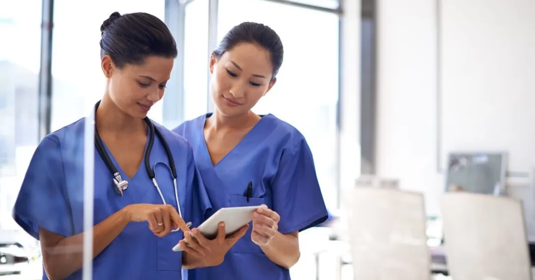 Nurses using a mobile tablet
