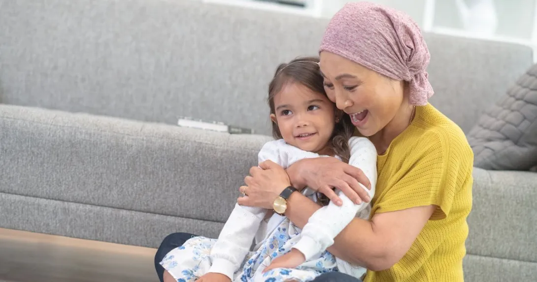 A woman holding a child while playing