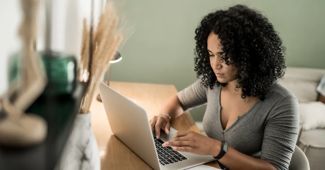 A young woman using a laptop.